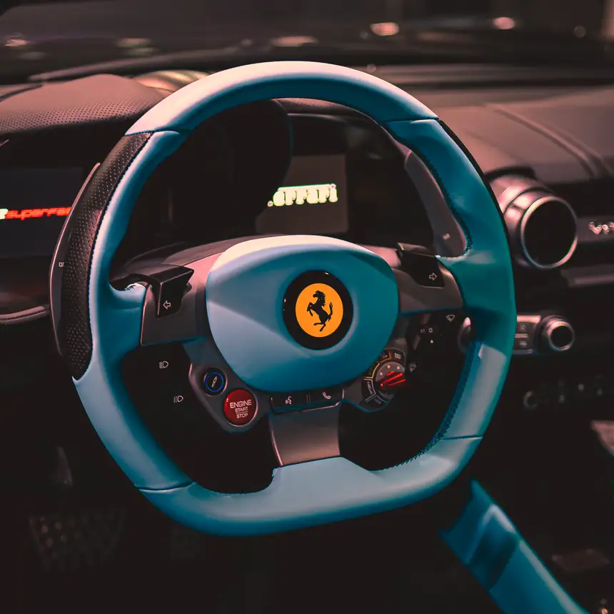Steering wheel of a Ferrari, trimmed in turquoise leather