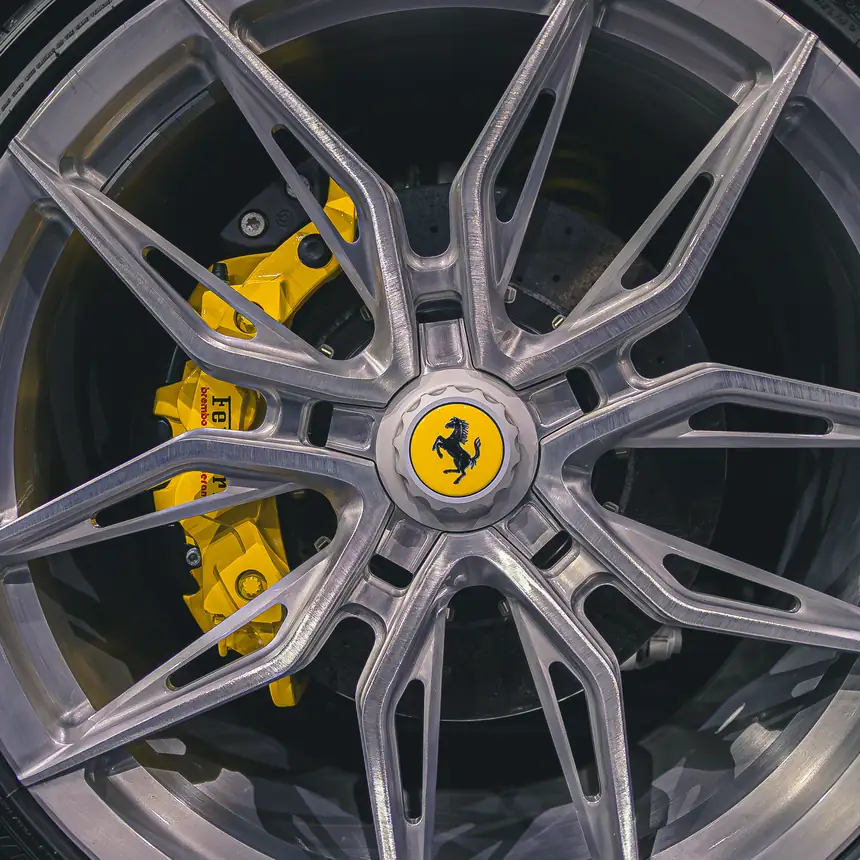 Wheel of a Ferrari with a yellow brake caliper